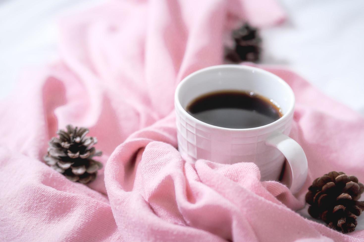 Christmas composition. Cup of coffee, scarf on pink background. Christmas, winter concept. Flat lay, top view, copy space photo