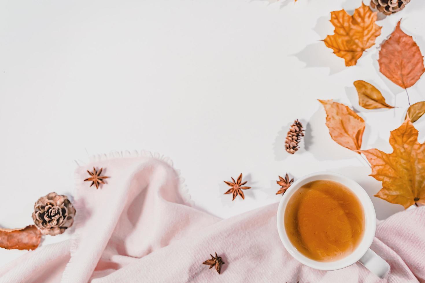 Cup of coffee, autumn leaves , cinnamon sticks and anise stars on Bright Blue pastel  background. Flat lay, top view copy space. photo