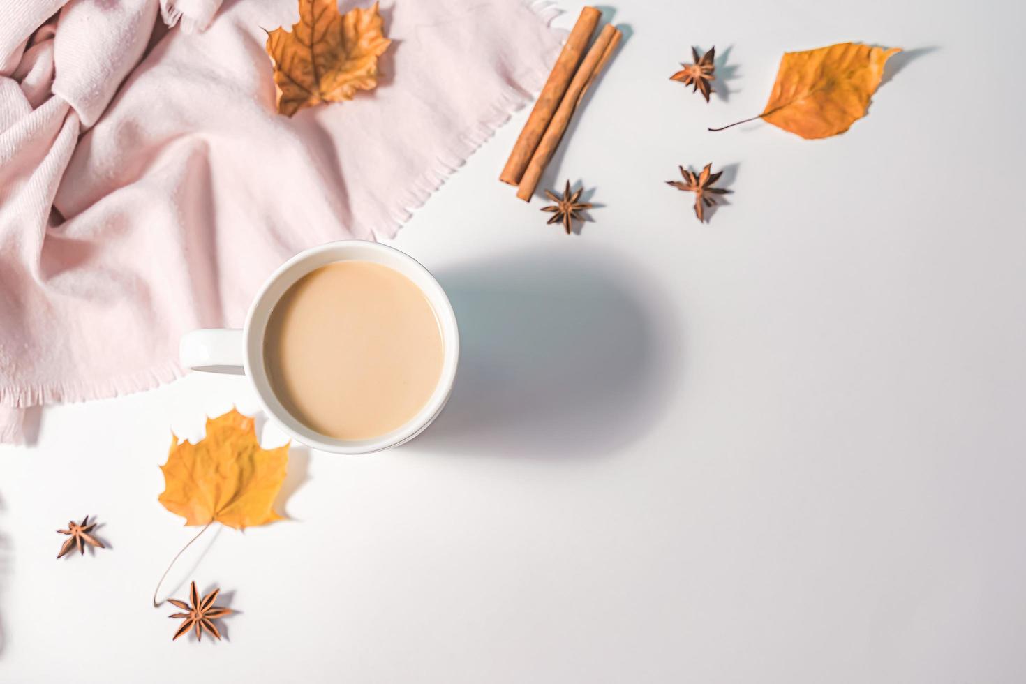 Autumn composition. Cup of coffee, autumn leaves , cinnamon sticks and anise stars on Bright Blue pastel  background. Flat lay, top view copy space. photo
