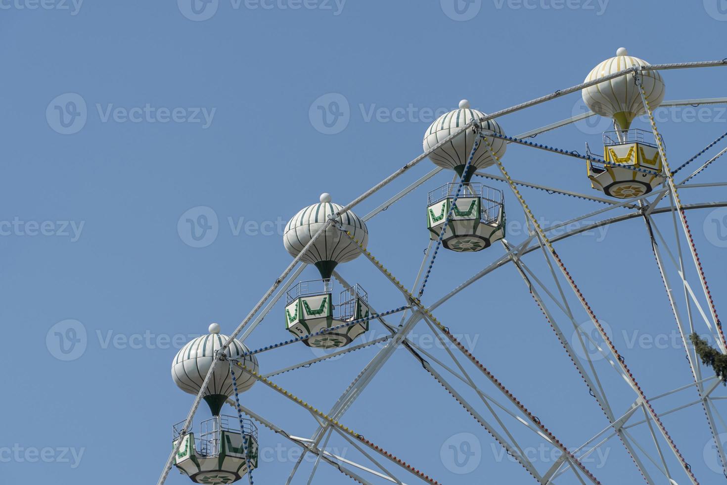 Ferris wheel on the background of blue sky photo