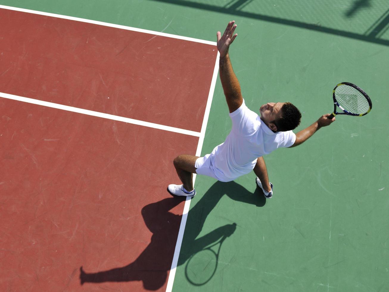 young man play tennis outdoor photo