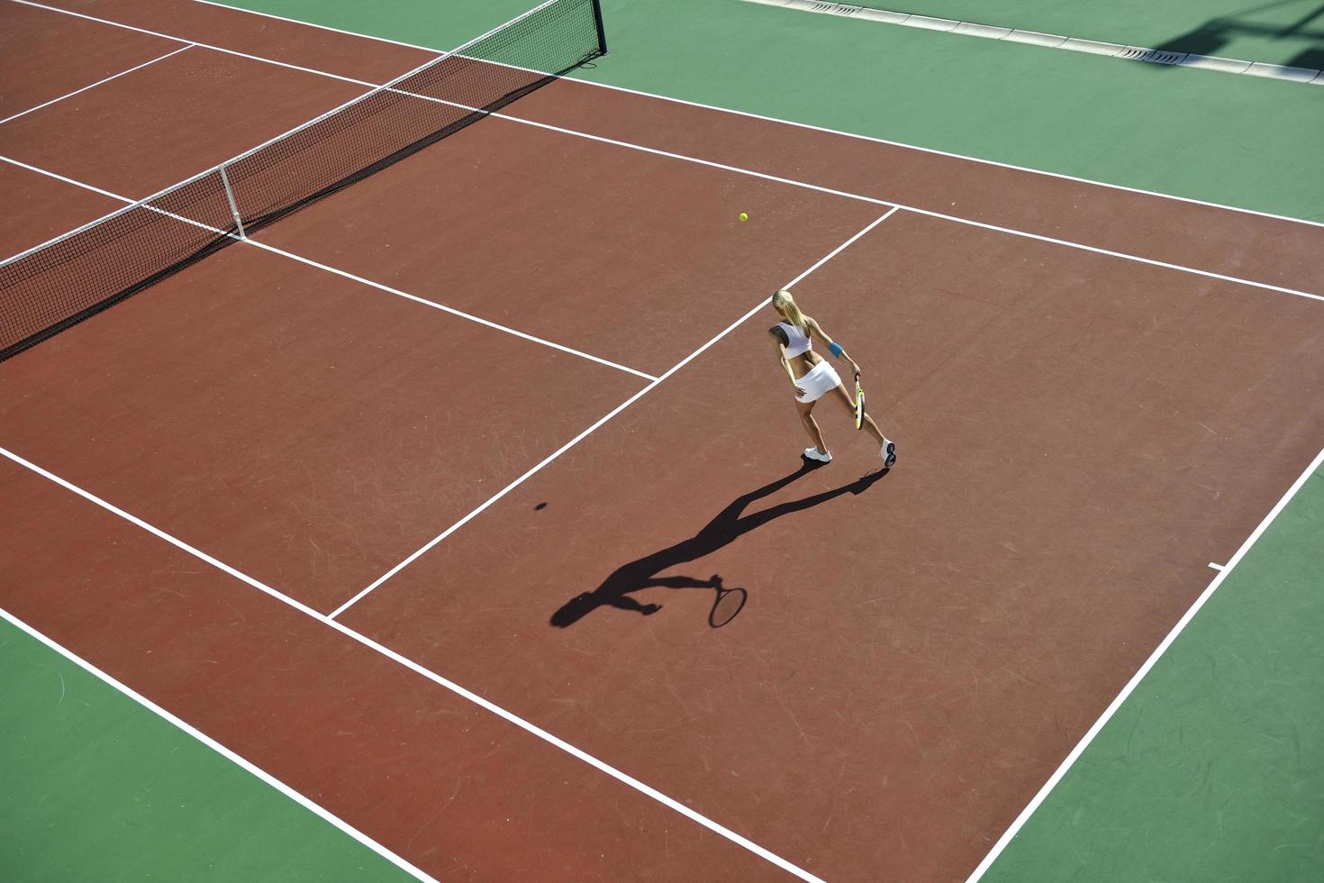 young woman play tennis outdoor photo