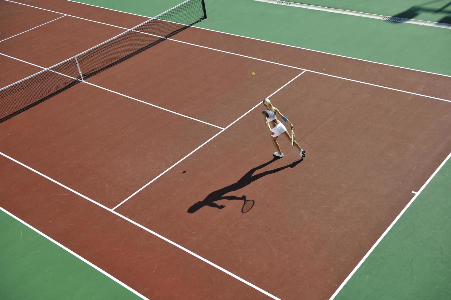 young woman play tennis outdoor photo