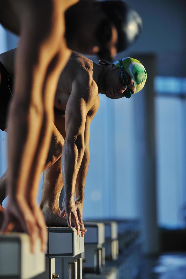 young swimmmer on swimming start photo