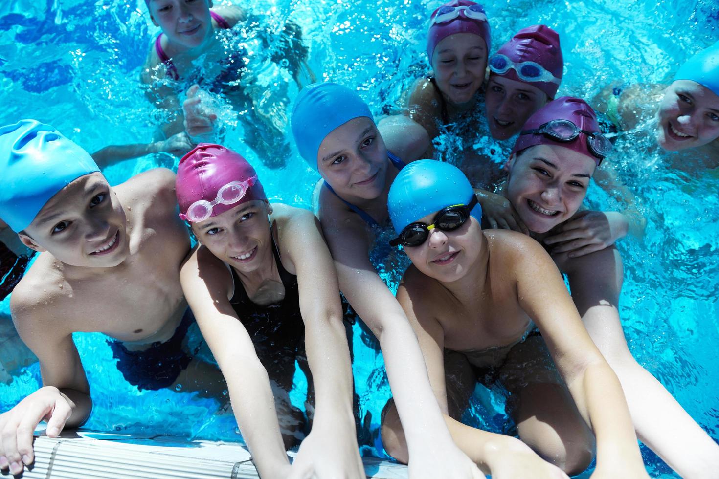 happy children group  at swimming pool photo