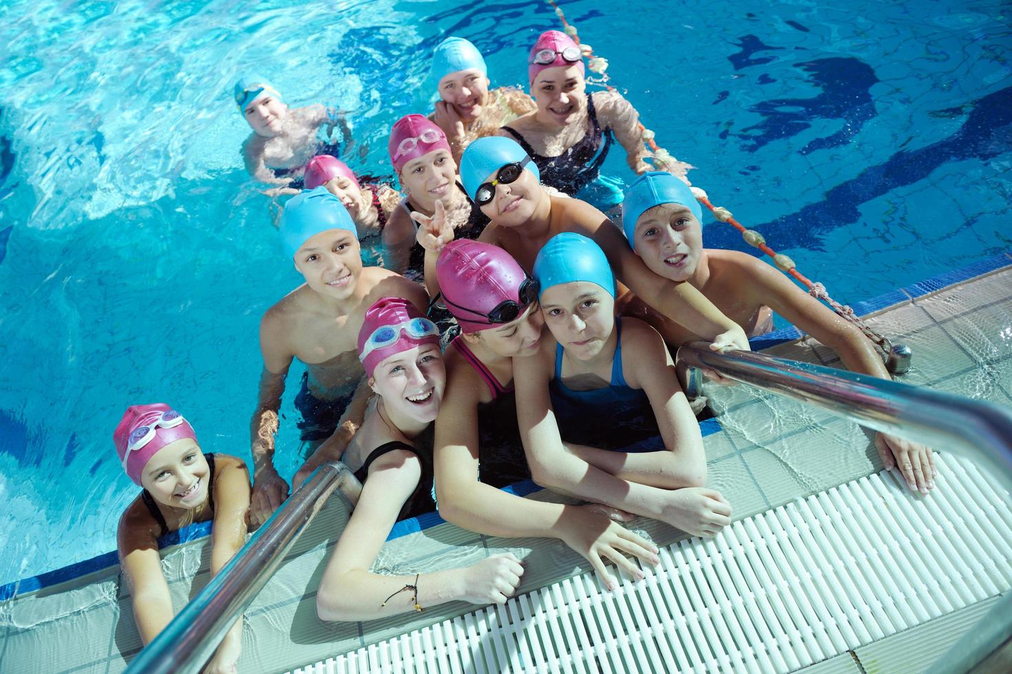 happy children group  at swimming pool photo