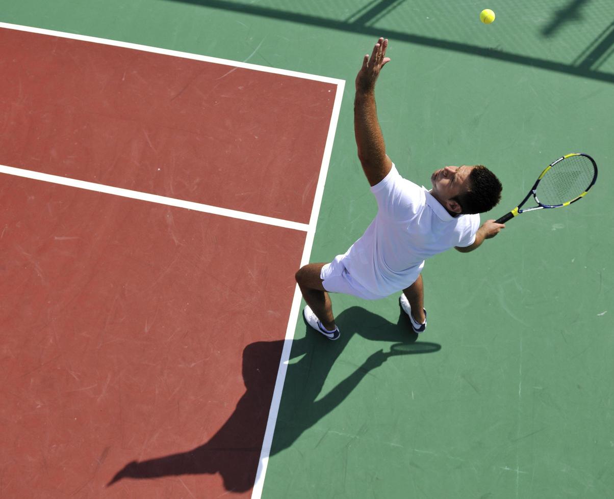 young man play tennis outdoor photo