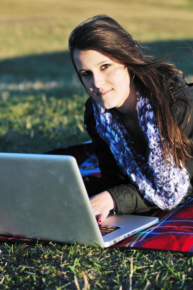 young teen girl work on laptop outdoor photo