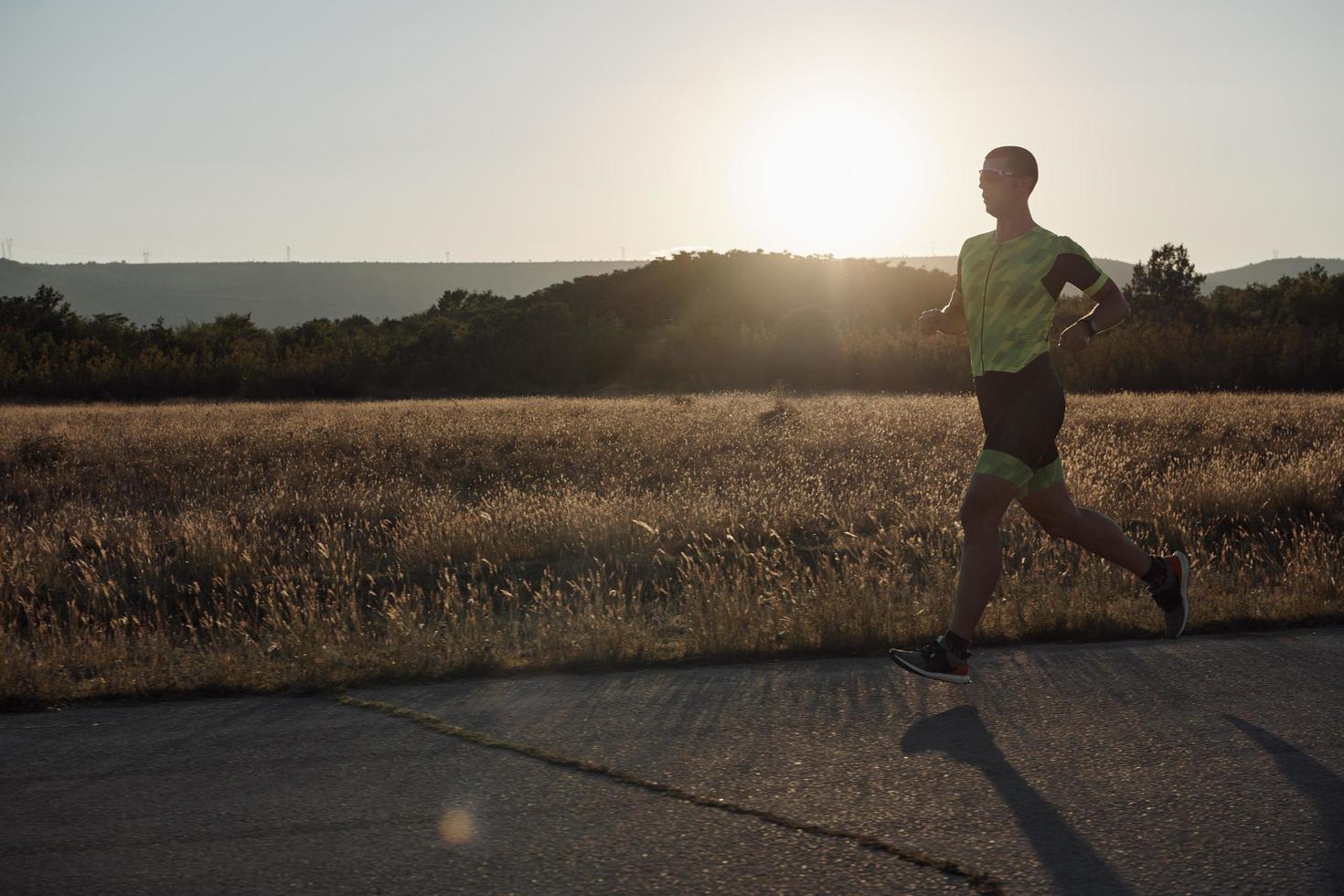 triathlon athlete running on morning trainig photo