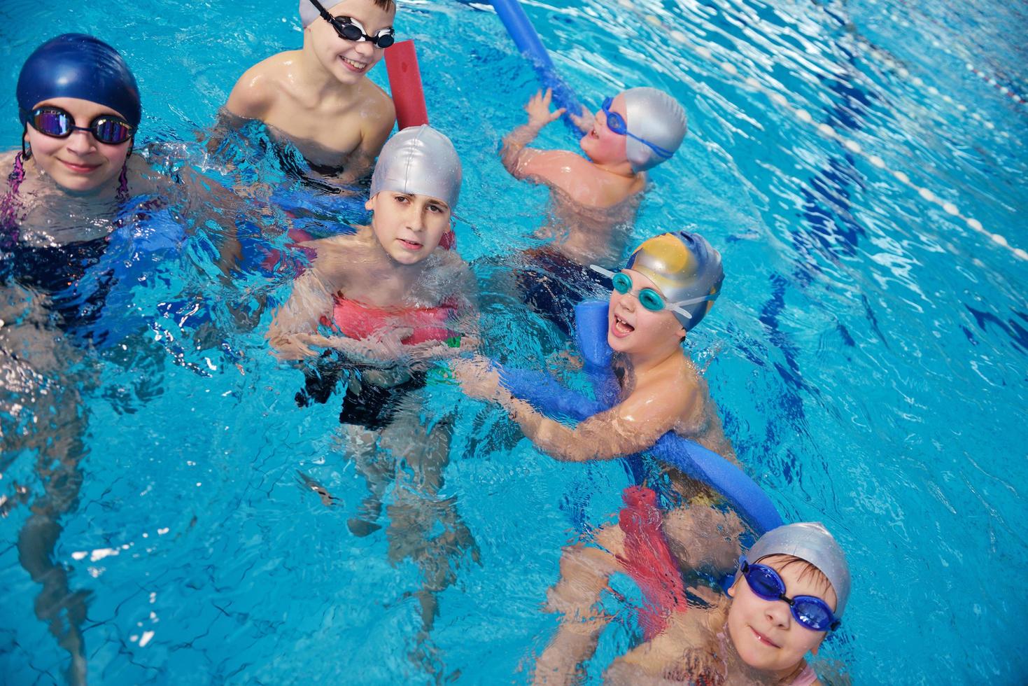 happy children group  at swimming pool photo