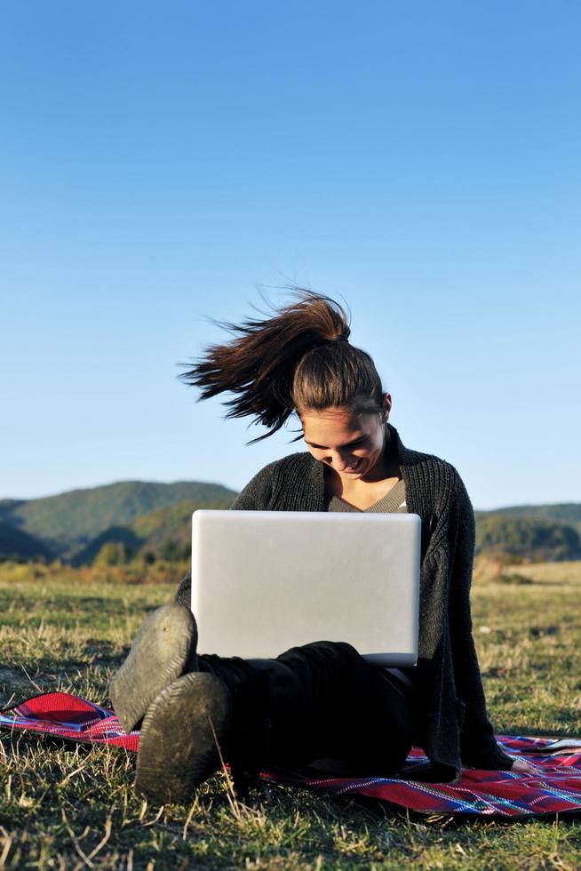 young teen girl work on laptop outdoor photo