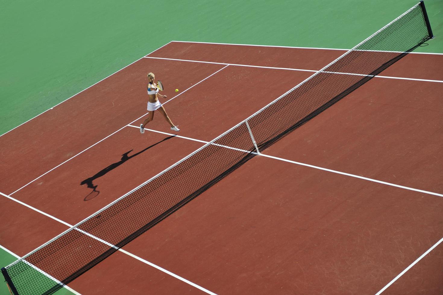 young woman play tennis outdoor photo