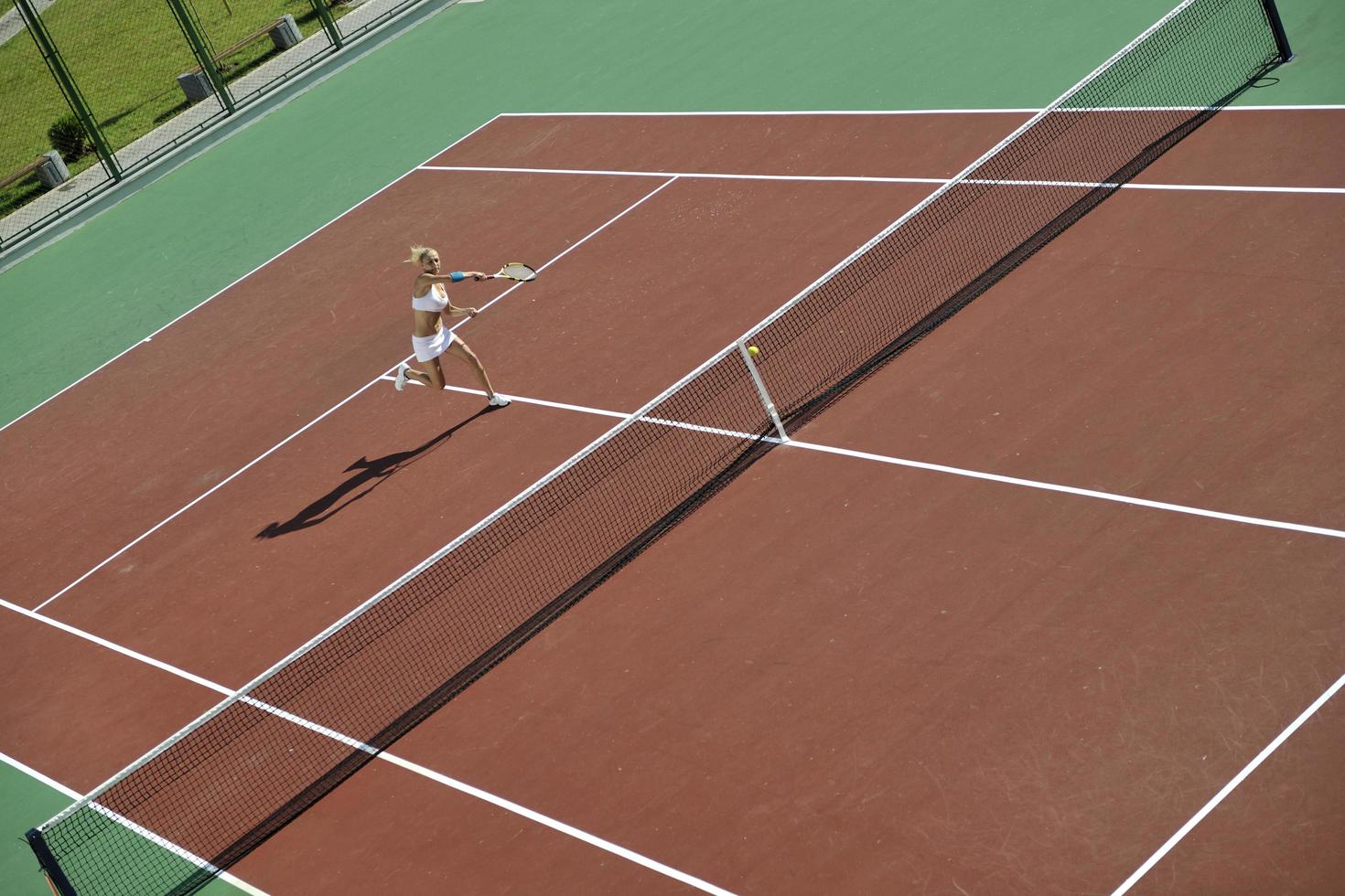 young woman play tennis outdoor photo