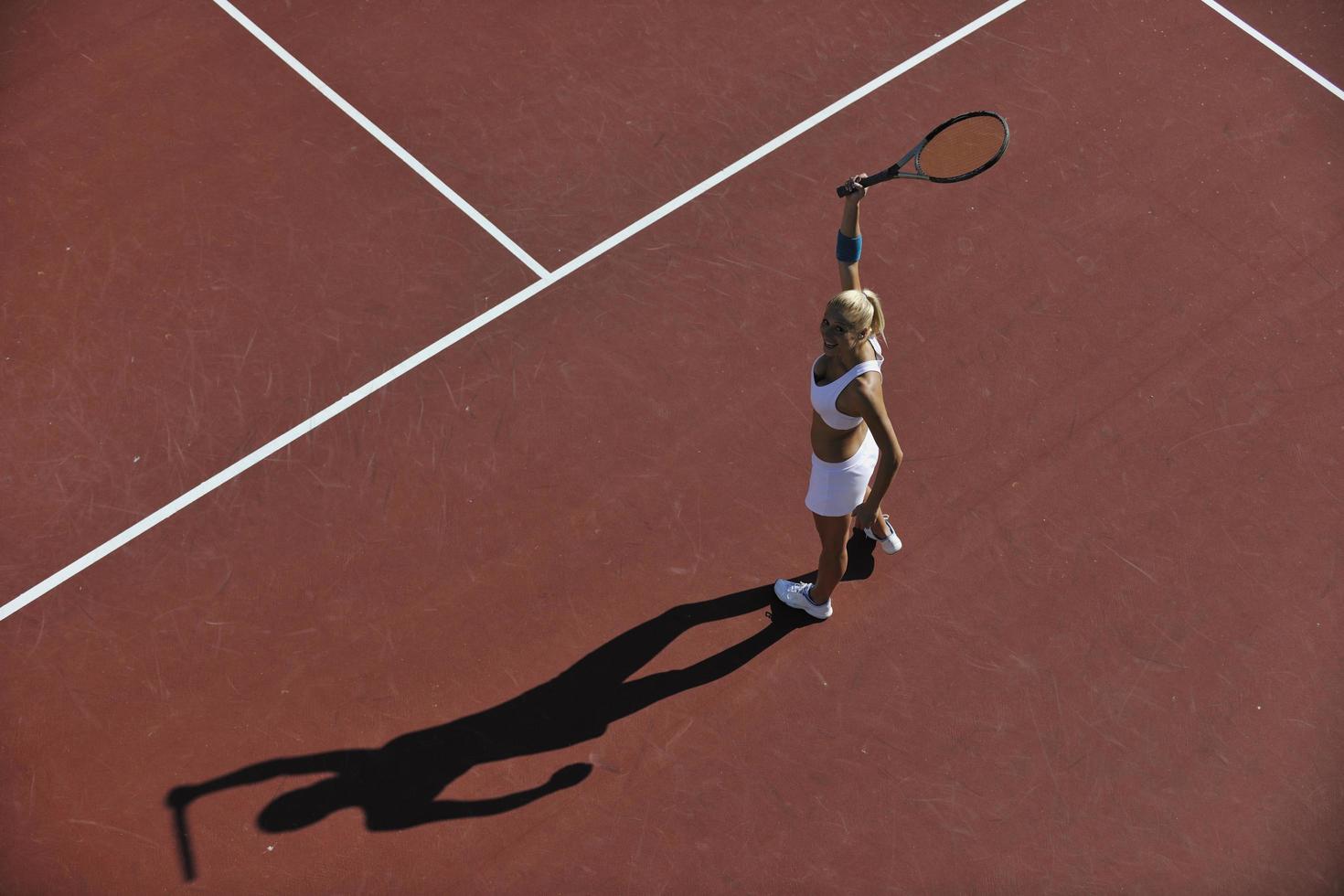 young woman play tennis outdoor photo