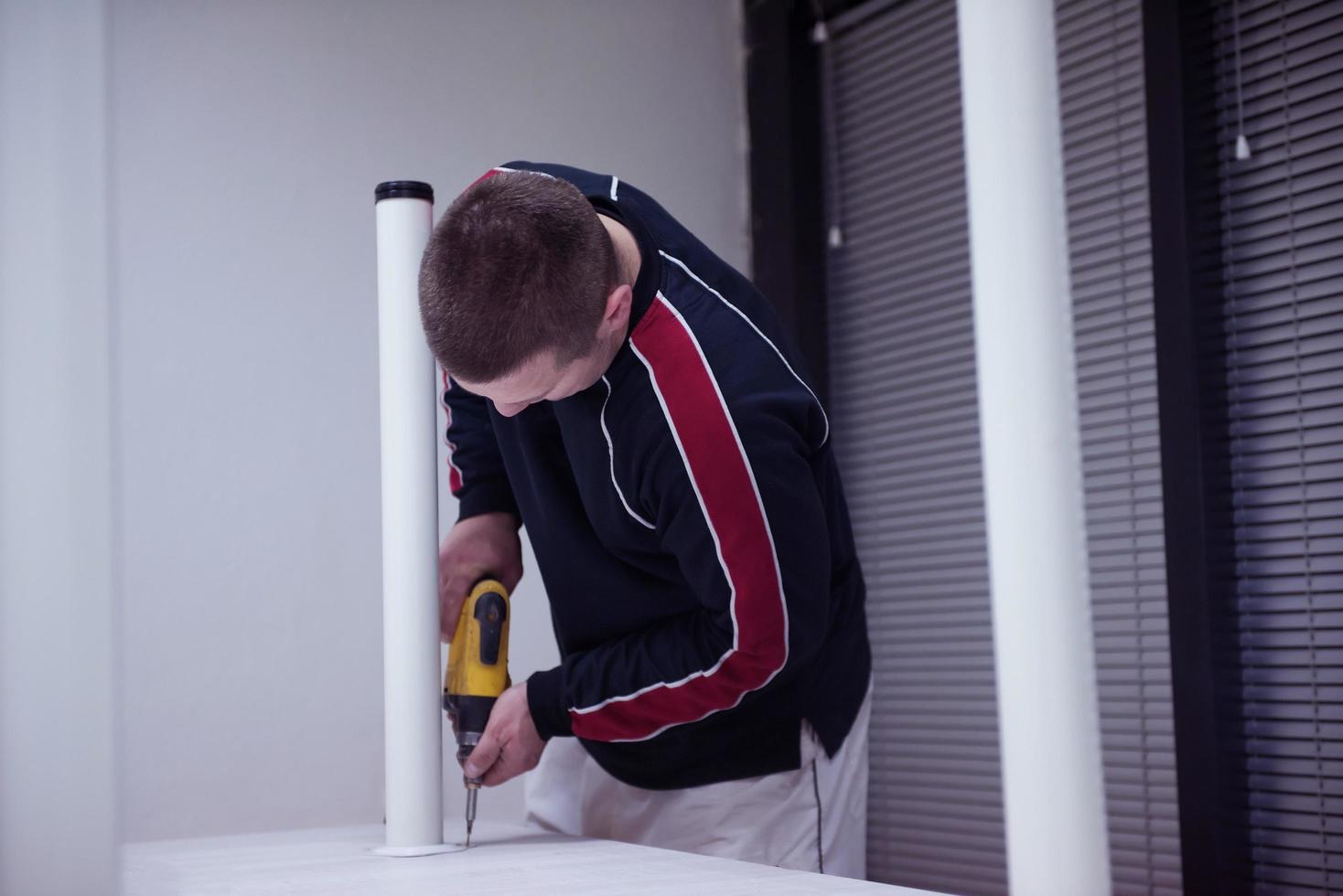 repairman working with drilling machine photo