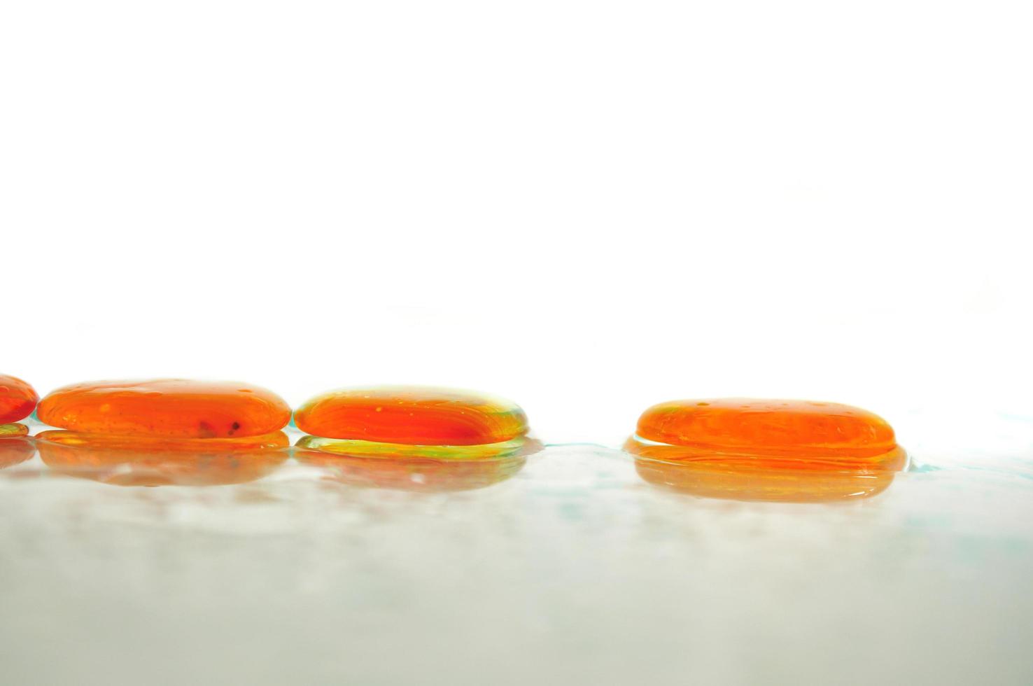 isolated wet zen stones with splashing  water drops photo