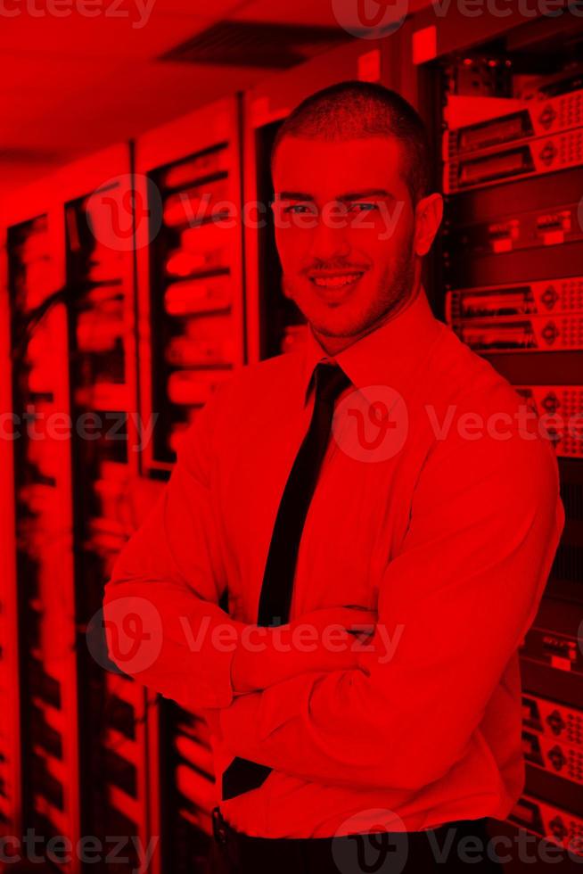 young it engineer in datacenter server room photo
