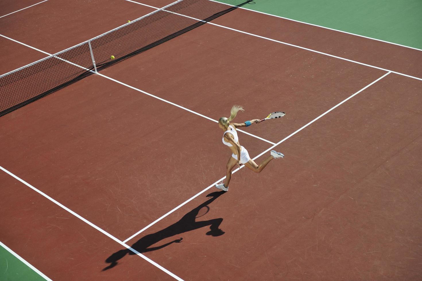 young woman play tennis outdoor photo