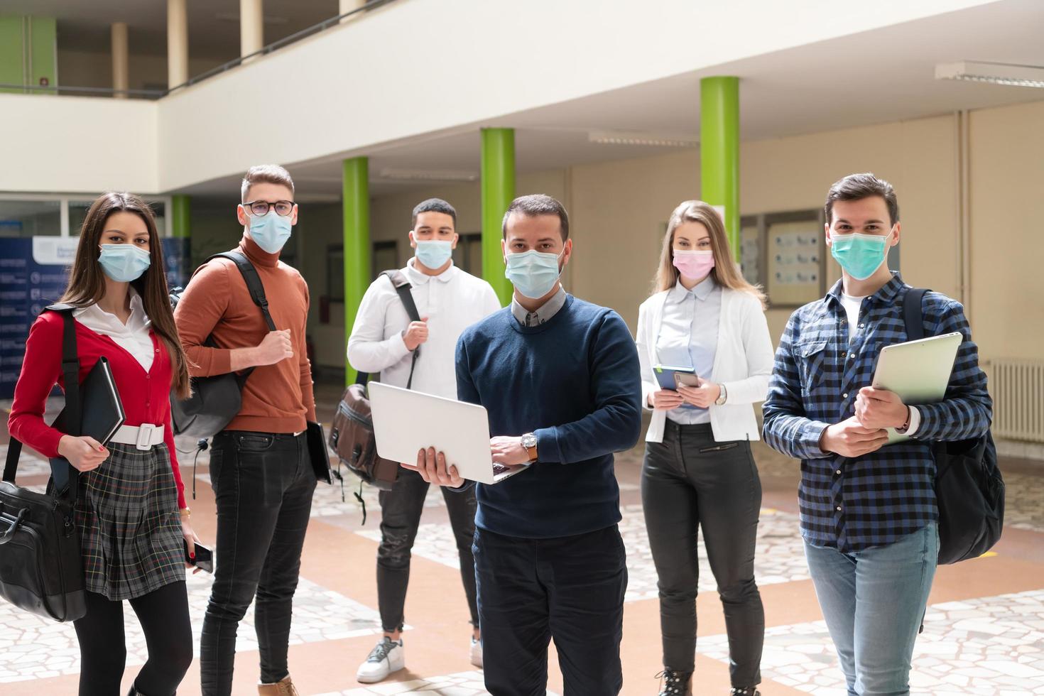 Multiethnic students group wearing protective face mask photo