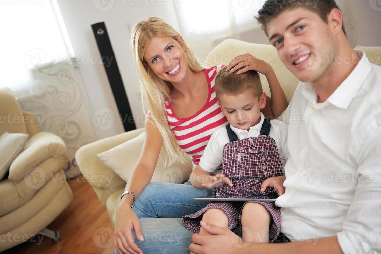 family at home using tablet computer photo