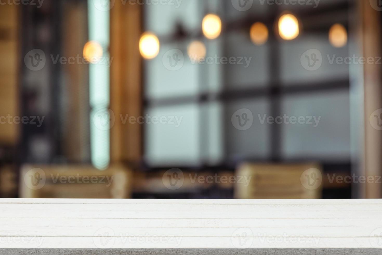 Empty wooden table top with view of room or wooden desk with restaurants with blur background, copy space for your text photo