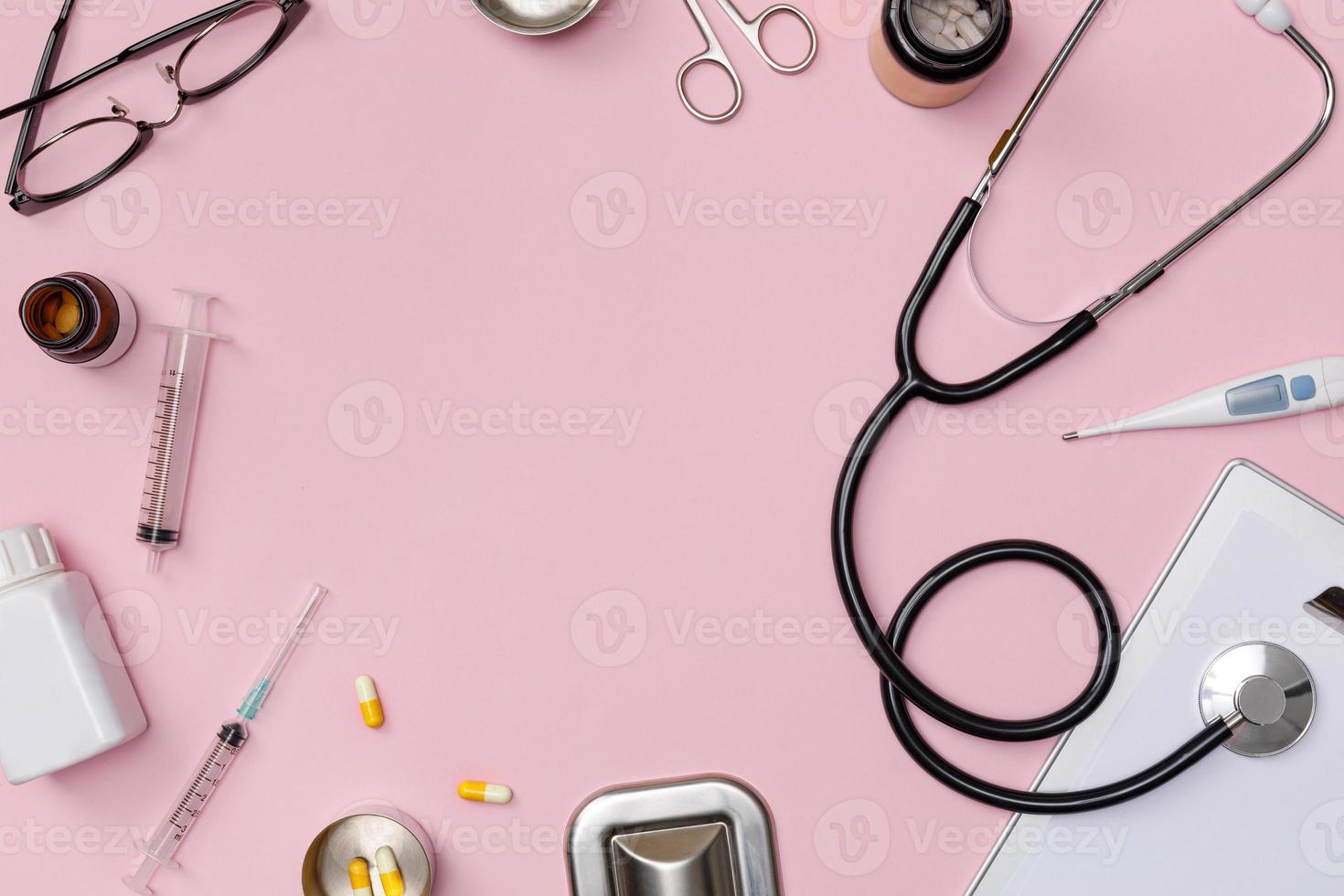 Creative flatlay of doctor medical equipment pink table with stethoscope, medical documents, thermometer, syringe and pills, Health care concept, Top view with copy space, Isolated on pink photo