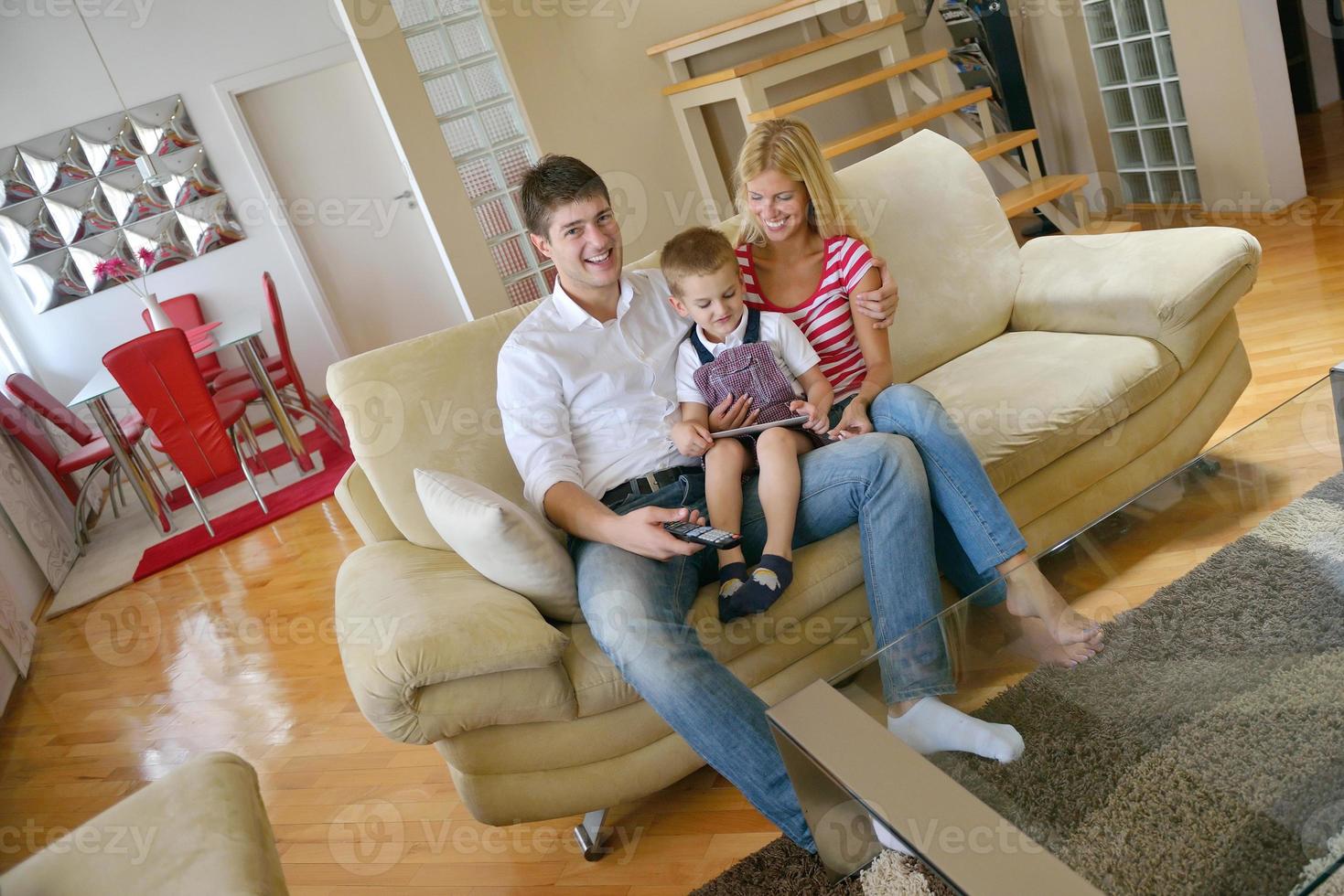 family at home using tablet computer photo