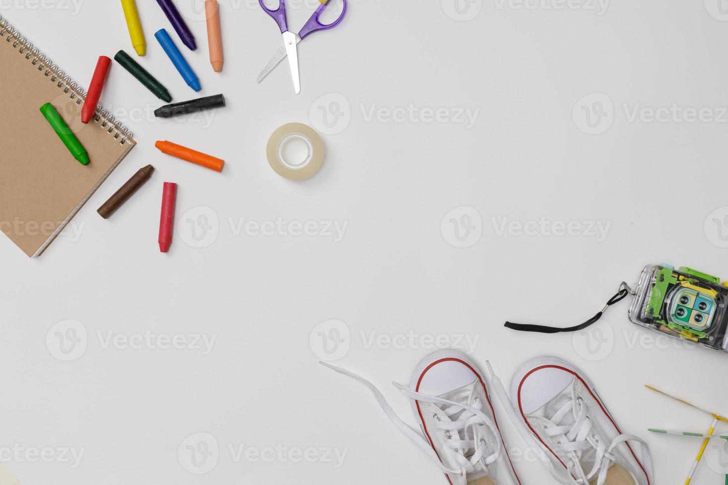 Creative flatlay of education white table with student books, shoes, colorful crayon, camera, empty space isolated on white background, Concept of education and back to school photo