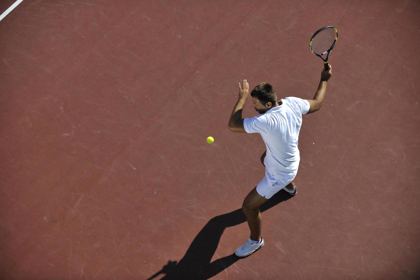 young man play tennis photo