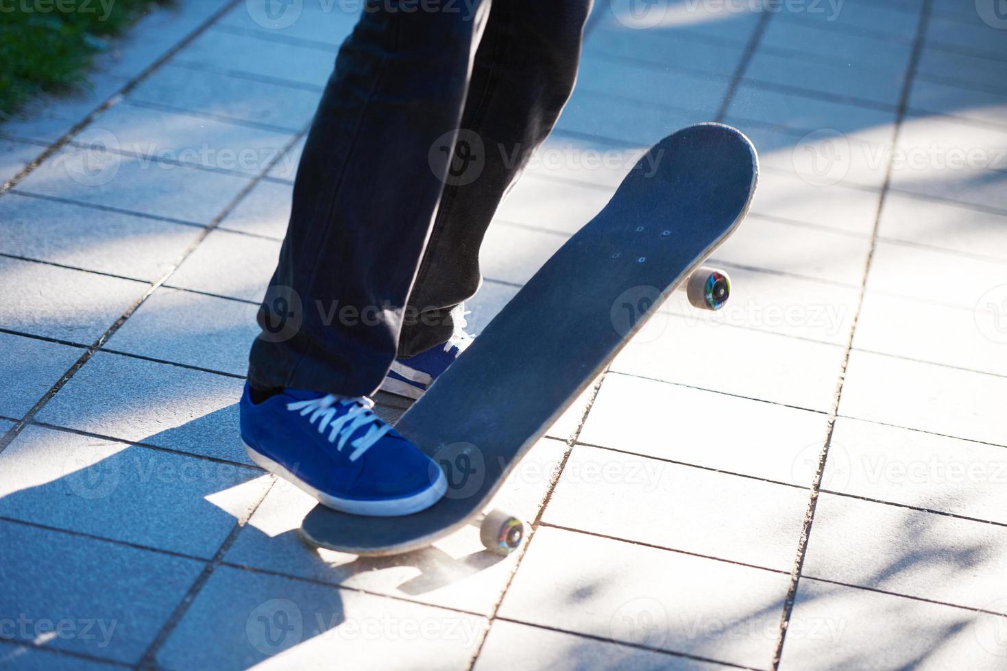 Skateboard jumping on sidewalk photo