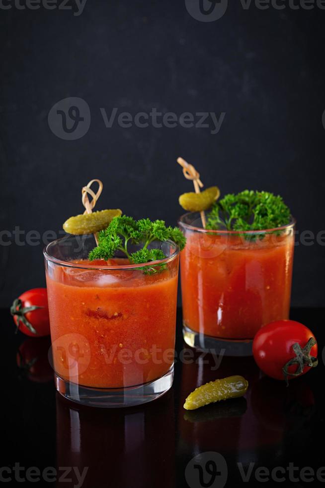 Alcohol cocktail Bloody Mary on dark background. Classic cocktail with tomato juice and vodka photo