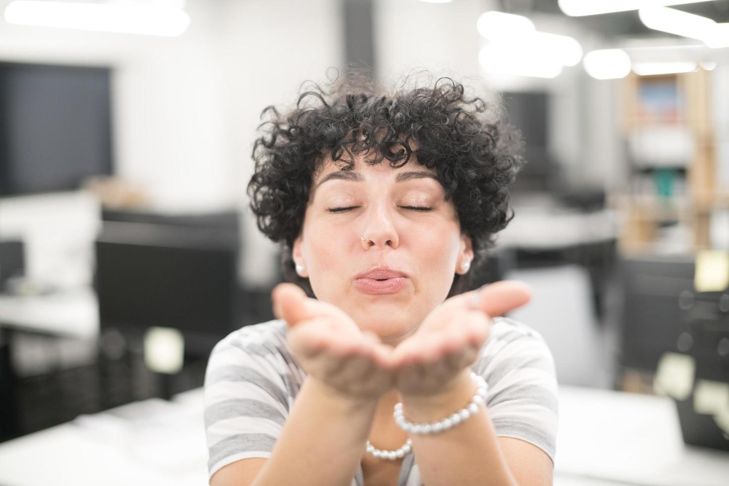 Woman blowing hands photo