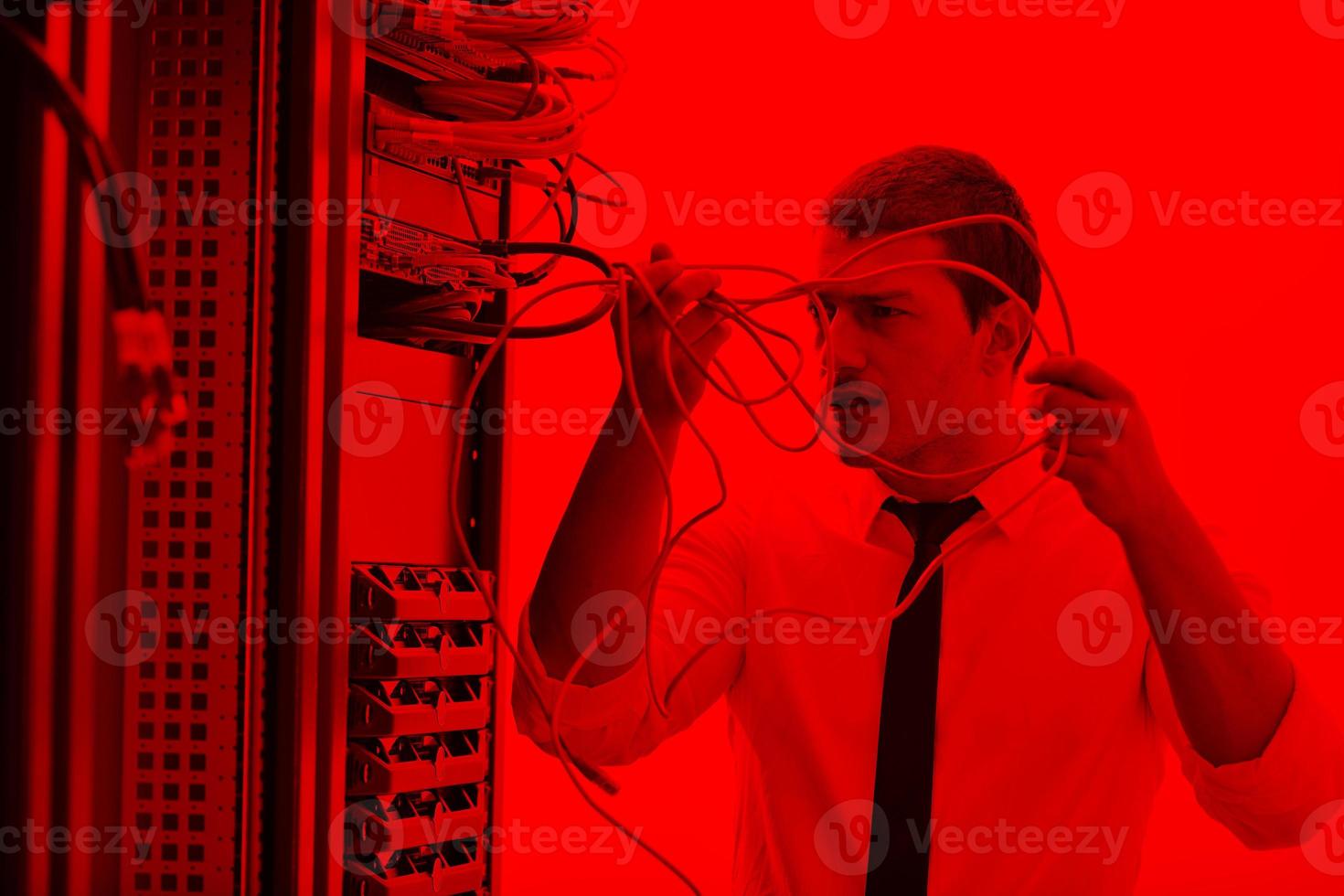 young engeneer in datacenter server room photo