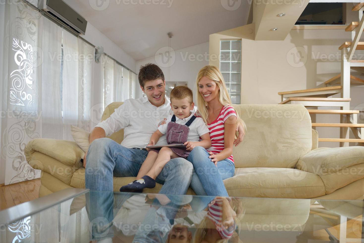 family at home using tablet computer photo