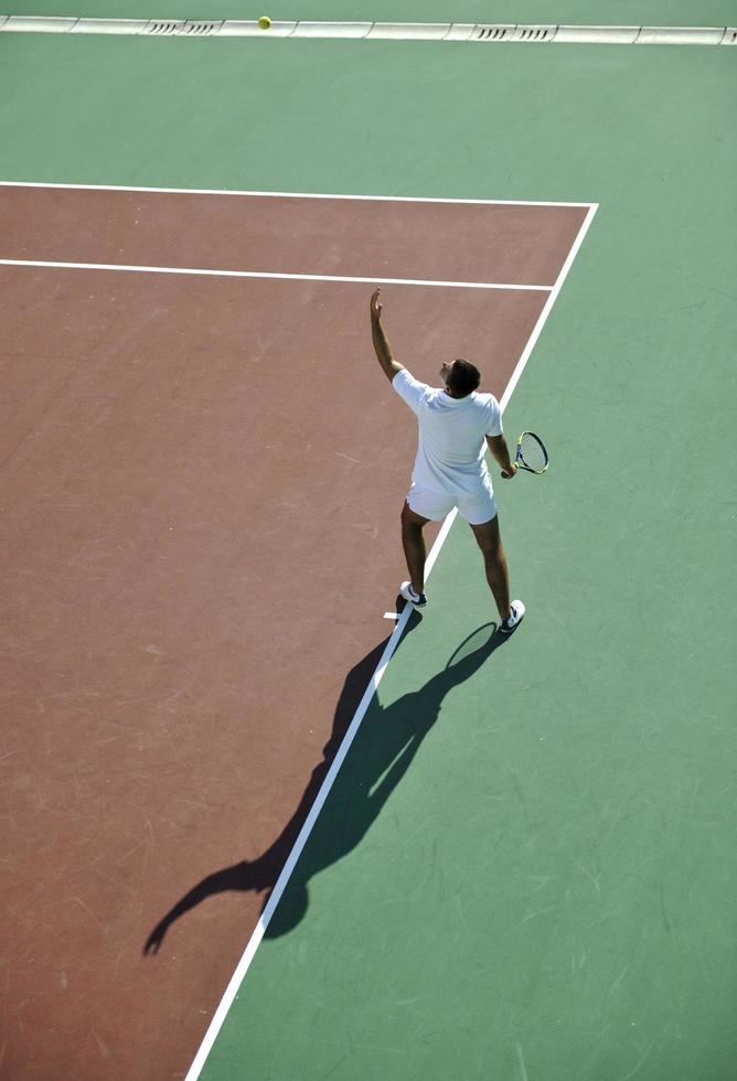 young man play tennis photo