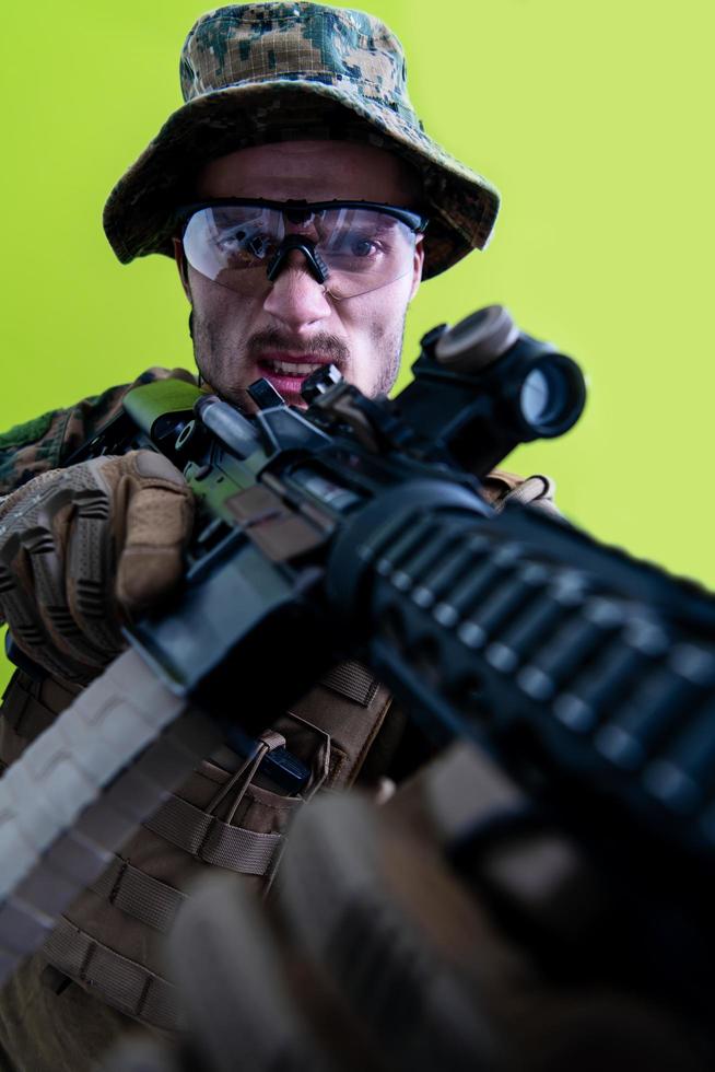 soldier in action aiming laseer sight optics green background photo