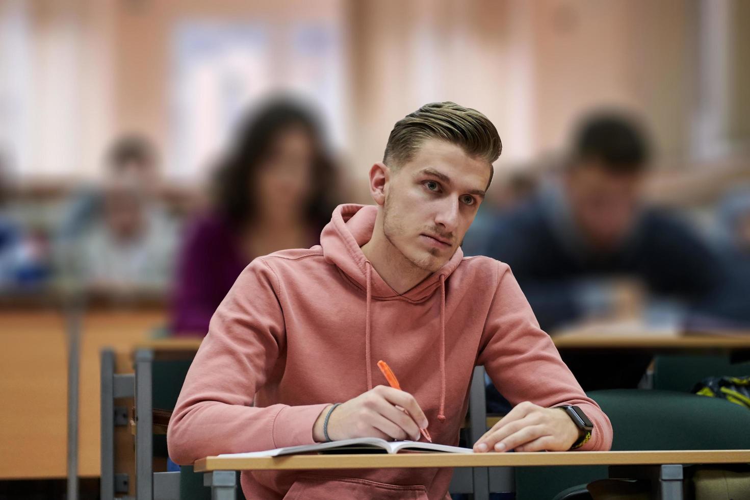 student taking notes while studying in high school photo