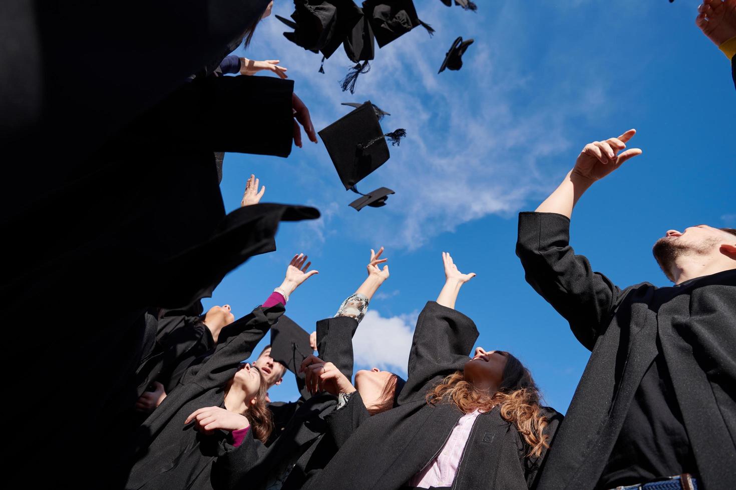 Group of diverse international graduating students celebrating photo