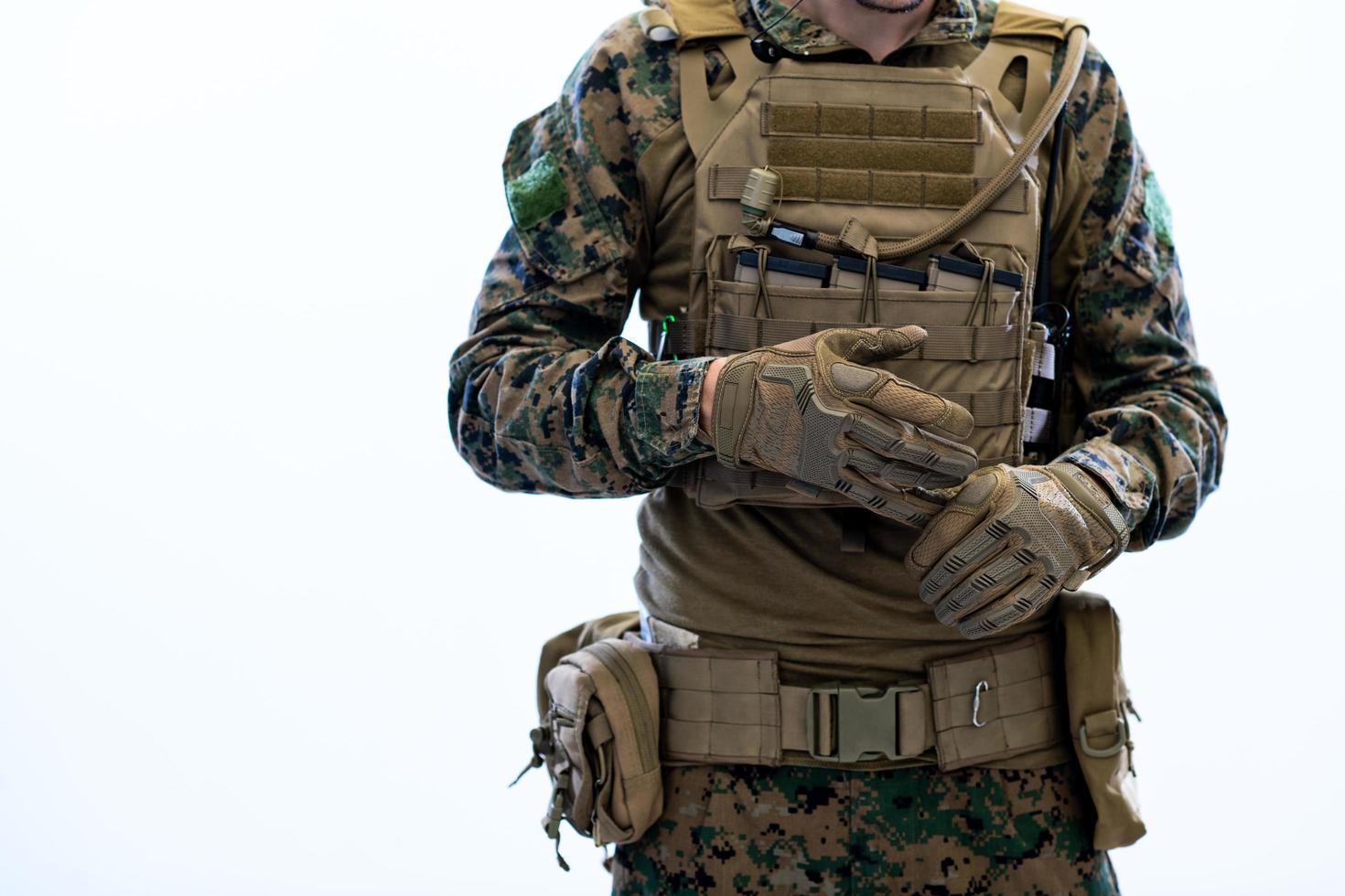closeup of soldier hands putting protective battle gloves photo