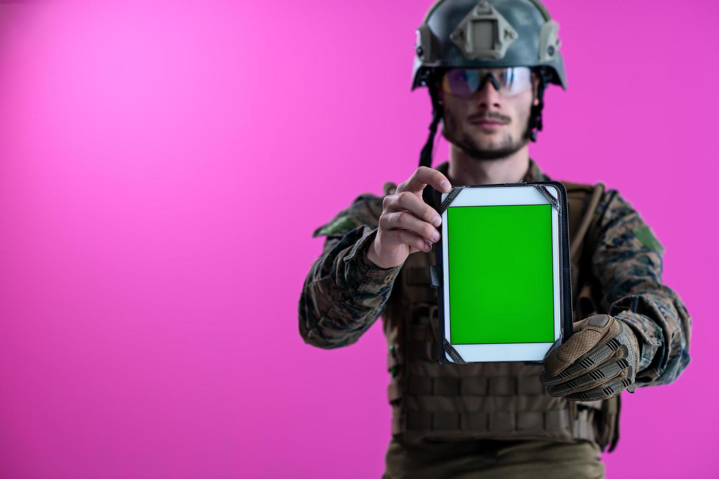 soldier showing a tablet with a blank green screen photo