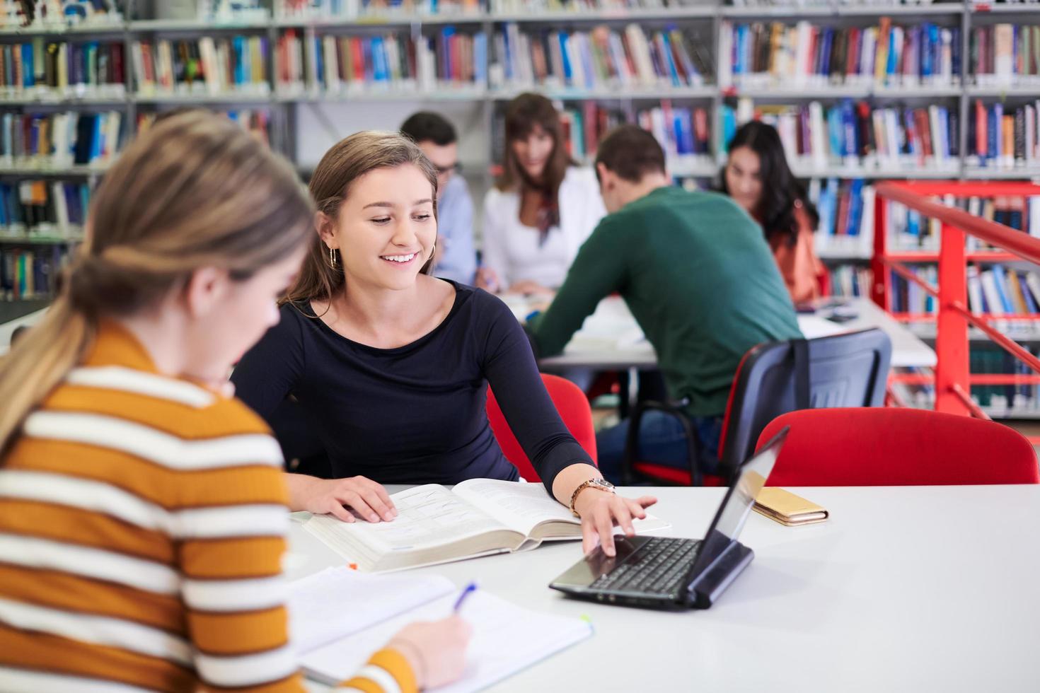 the student uses a notebook and a school library photo