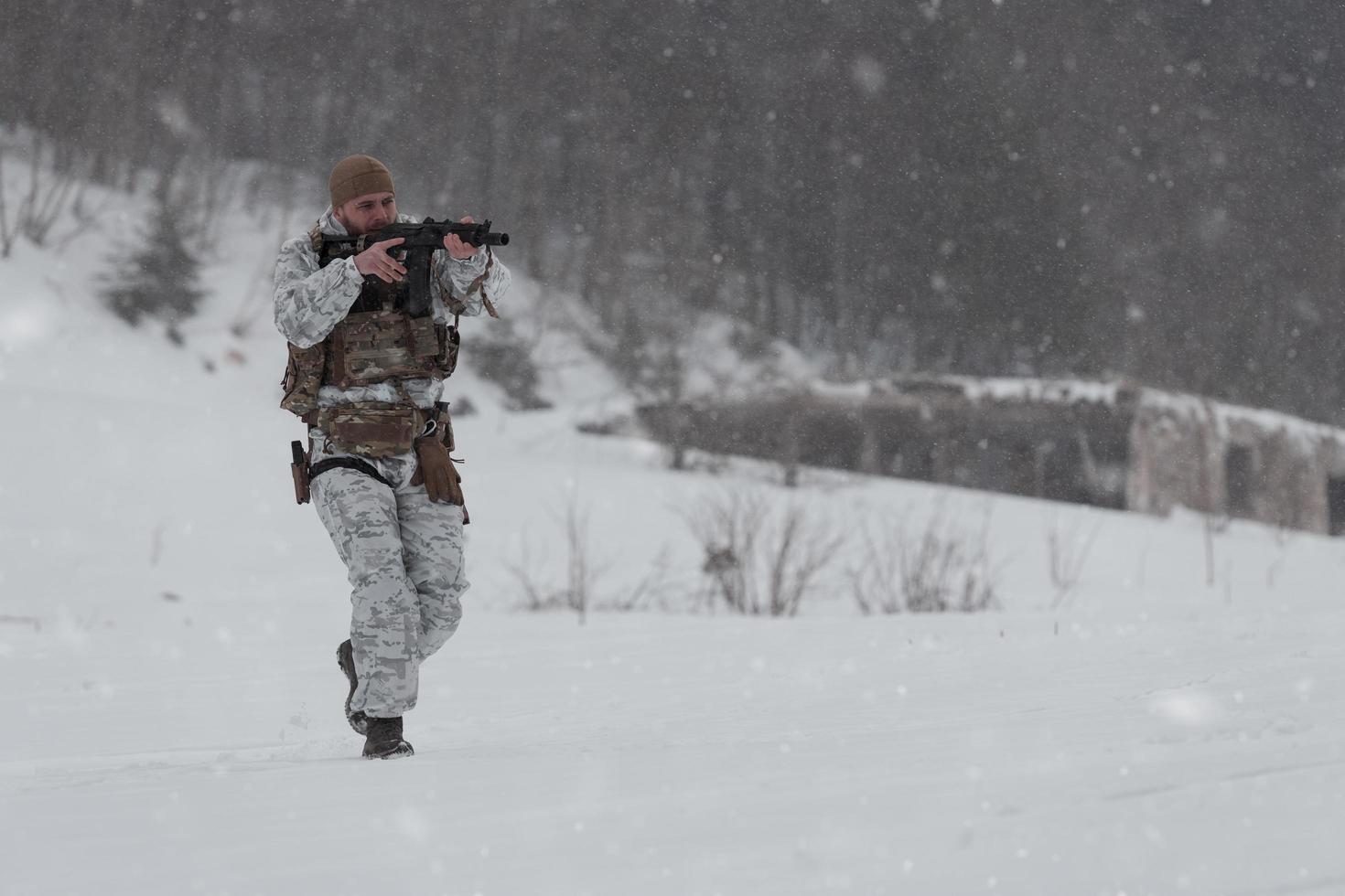 Winter war in the Arctic mountains. Operation in cold conditions.Soldier in winter camouflaged uniform in Modern warfare army on a snow day on forest battlefield with a rifle. Selective focus photo