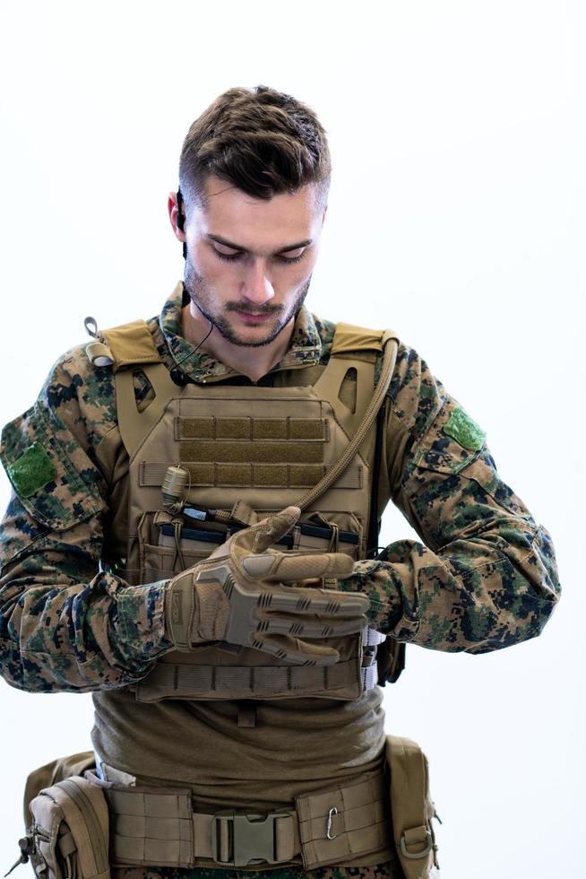 closeup of soldier hands putting protective battle gloves photo