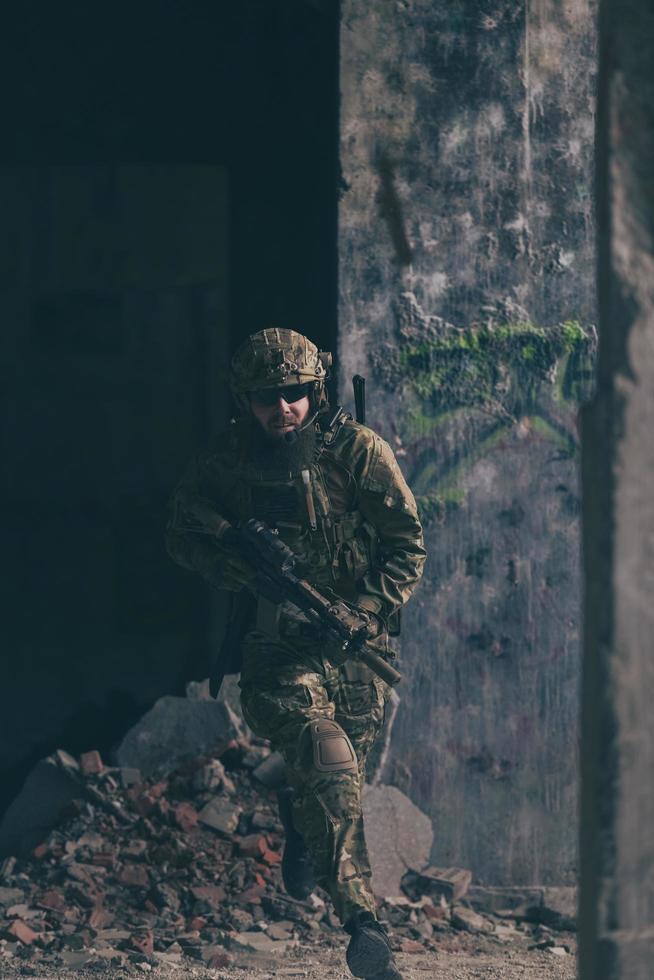 A bearded soldier in uniform of special forces in a dangerous military action in a dangerous enemy area. Selective focus photo