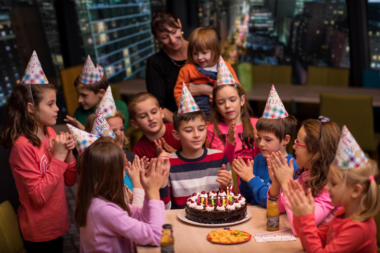 happy young boy having birthday party photo