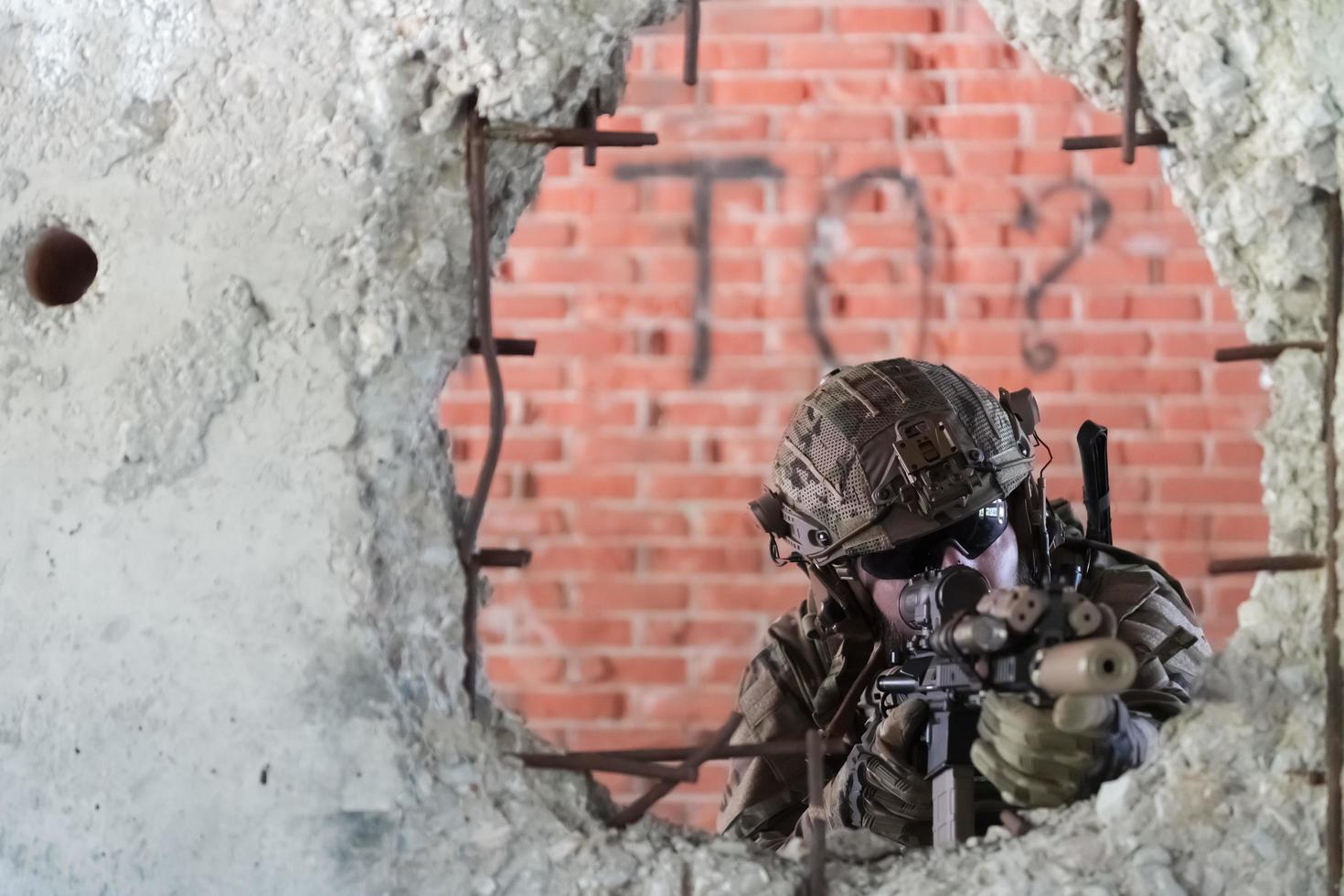 A bearded soldier in uniform of special forces in a dangerous military action in a dangerous enemy area. Selective focus photo