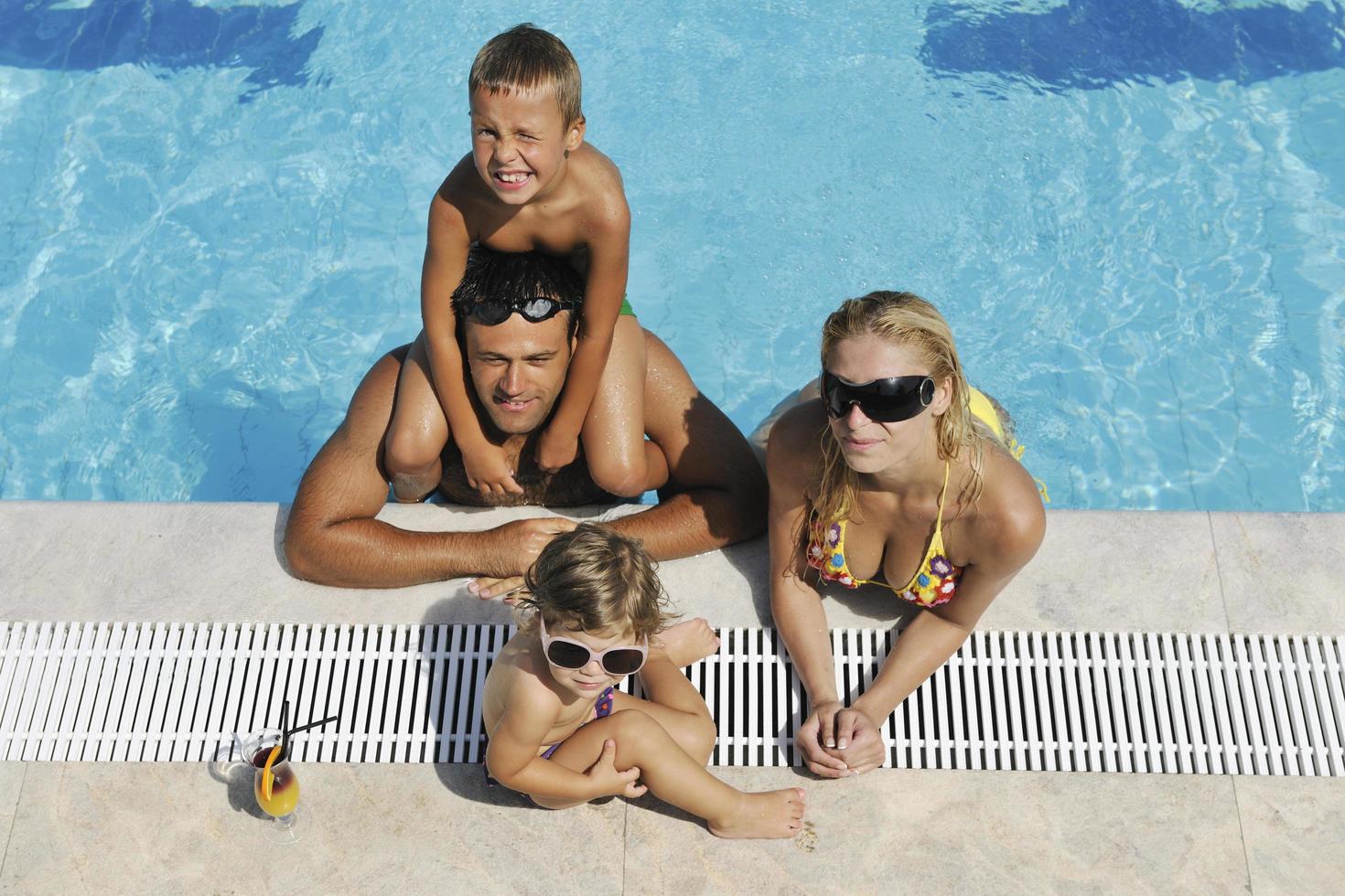 happy young family have fun on swimming pool photo