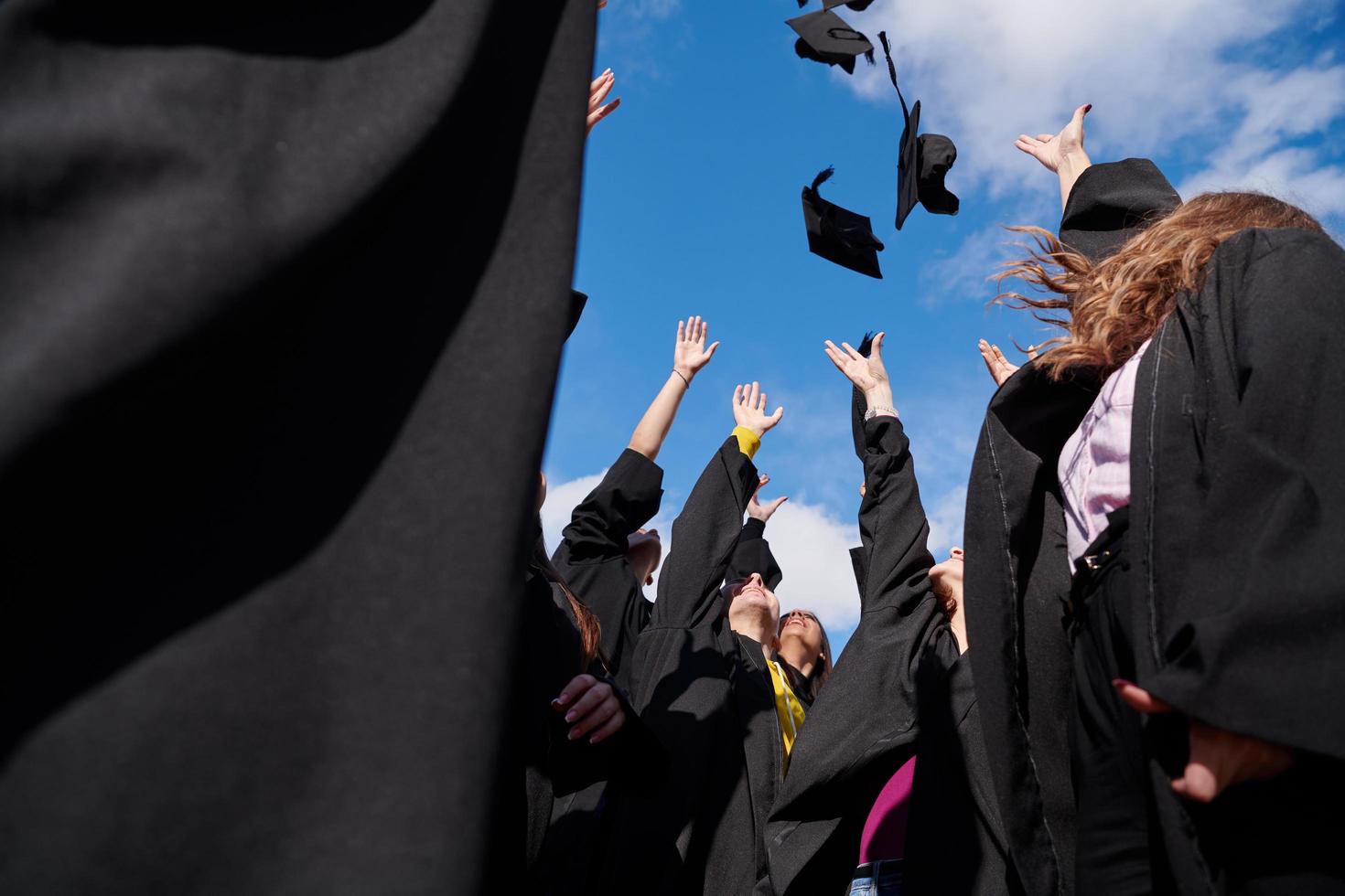 Group of diverse international graduating students celebrating photo