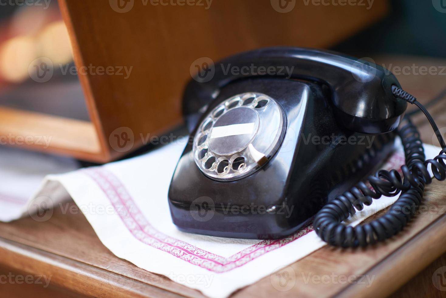 retro telephone on table photo