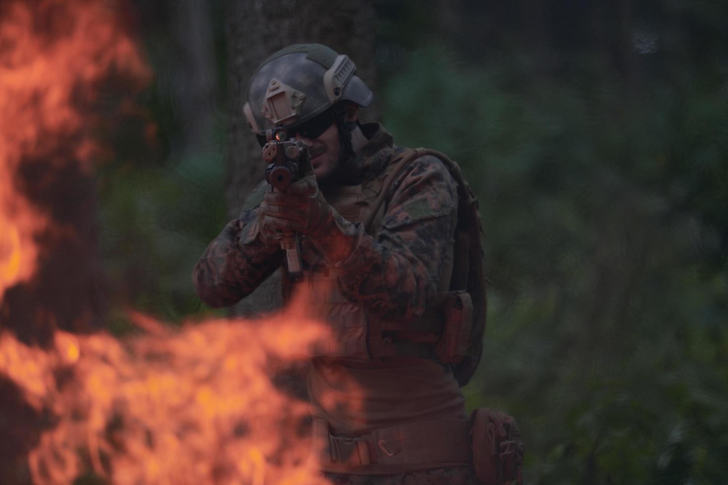 soldier in action aiming  on weapon  laser sight optics photo